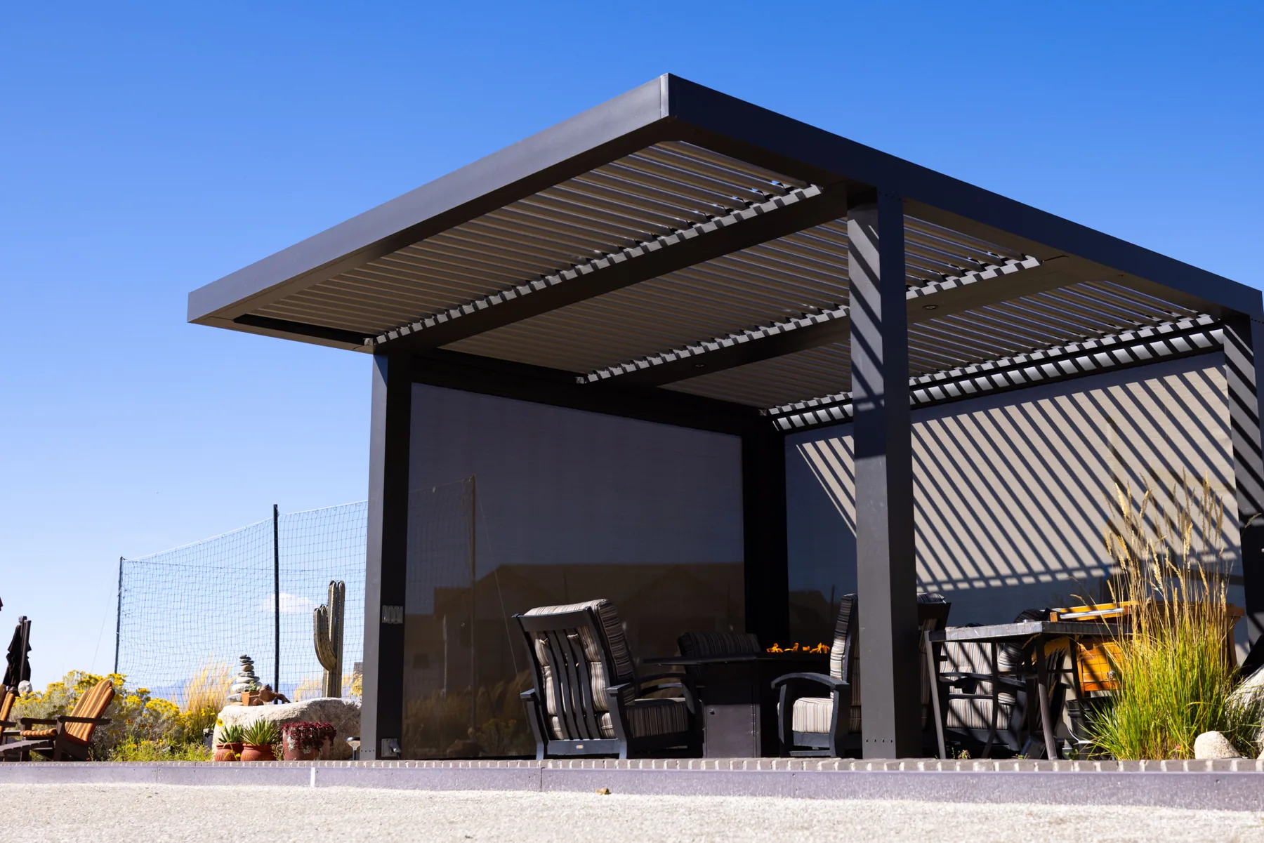 Dark louvered pergola with screen side