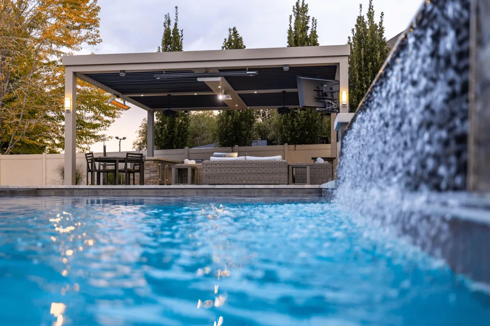 Pergola beside a pool and waterfall
