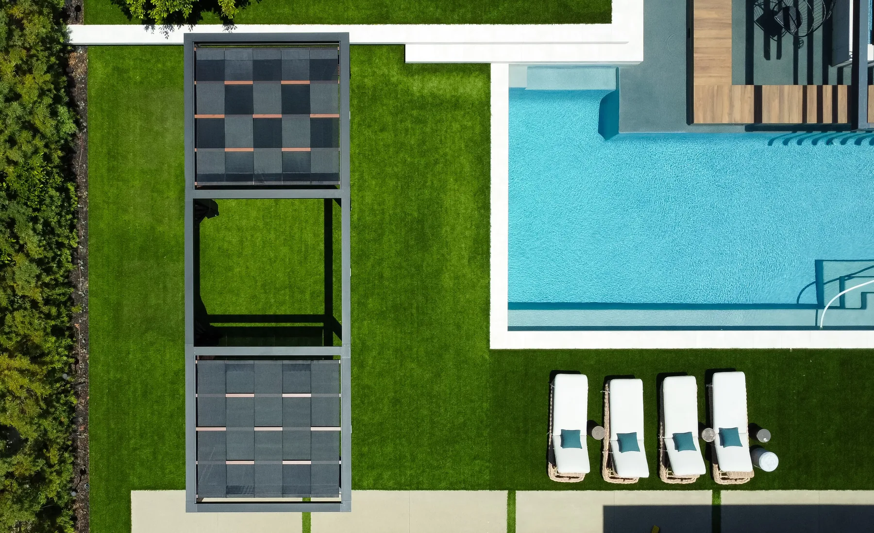 Top view of pergola over pool furniture