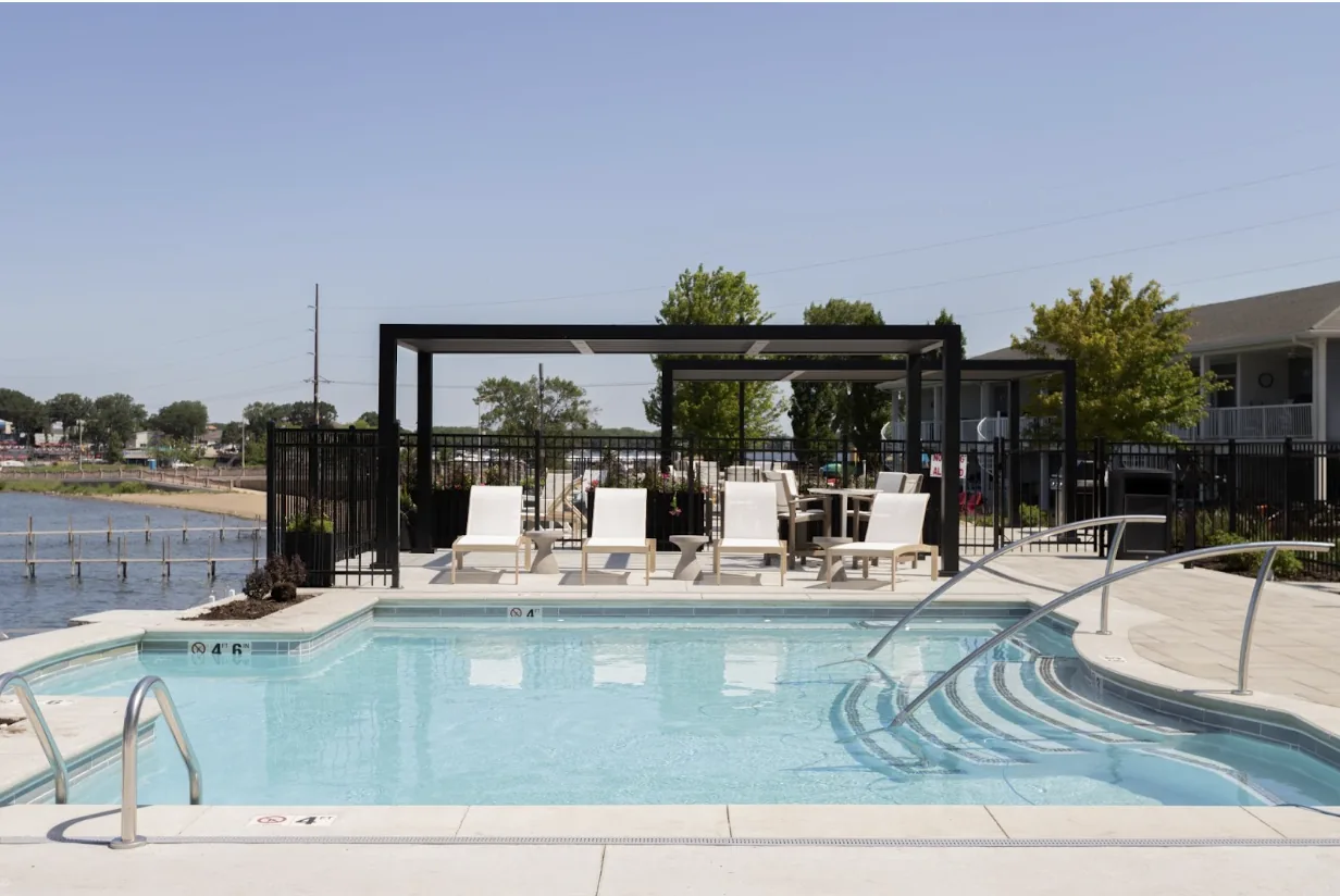 Black pergola beside a commercial pool