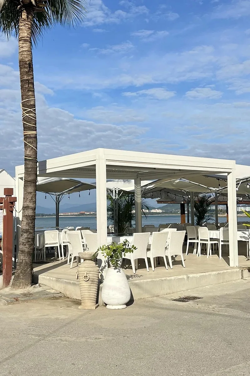 Beachfront white aluminum pergola for hospitality dining