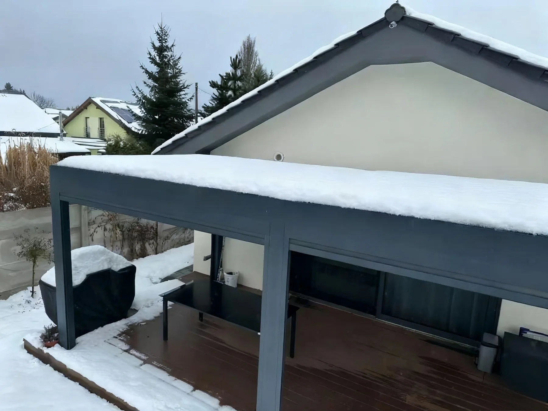Snow-covered aluminum pergola for cold climate terrace